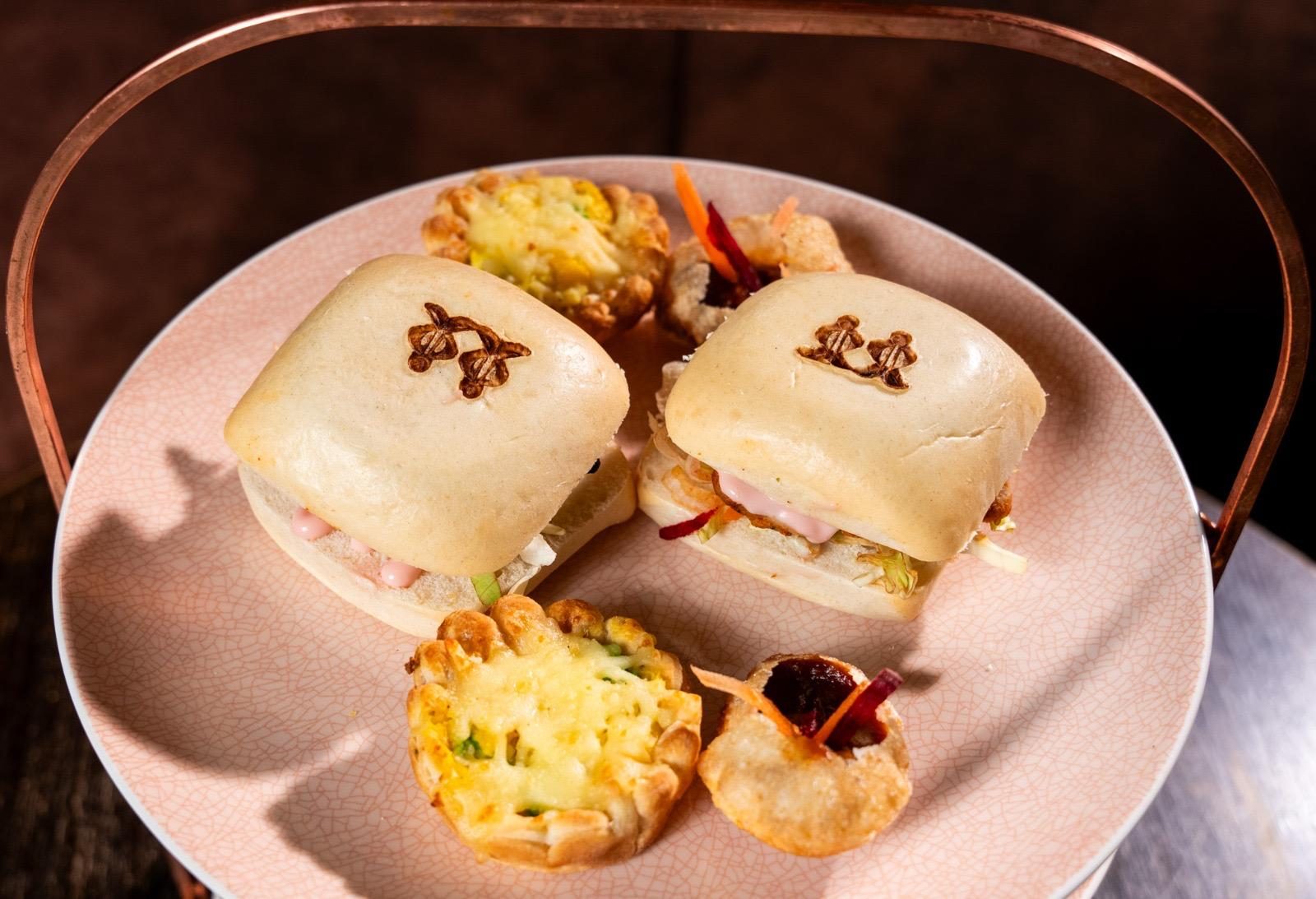 Bao buns and savoury tarts on a copper-handled stand
